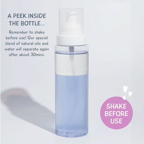 Transparent bottle showing MooGoo Natural Detangling Spray formula, natural oils and water separation with shake before use