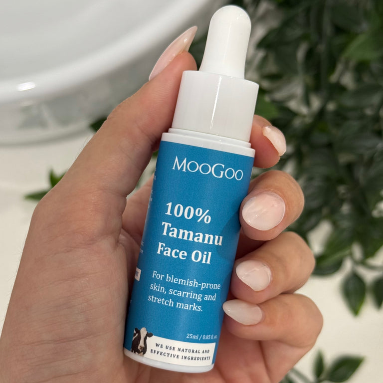 100% Tamanu face oil held in front of leafy background. For blemish prone skin, scarring and stretch marks.