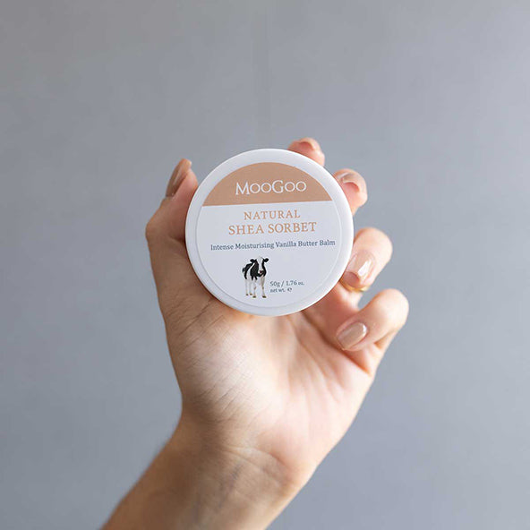 MooGoo Shea Sorbet Vanilla Butter Balm held in hand, natural skincare for chapped and cracked skin patches