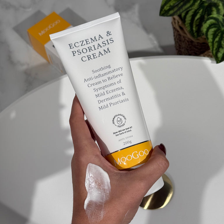 Eczema & Psoriasis Cream held with swatch spread on hand, Soothing anti inflammatory with Gotu Kola and Chamomile to relieve dry, red itchy skin, PH balancing formula, Dermatologically tested.