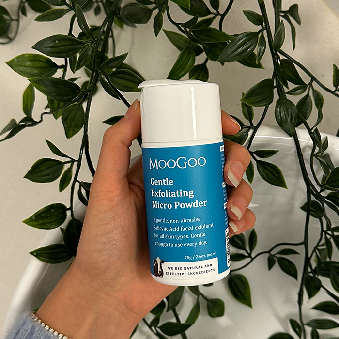 MooGoo Gentle Exfoliating Micro Powder shown in hand, plant-derived exfoliator to deep cleanse pores and smooth skin texture