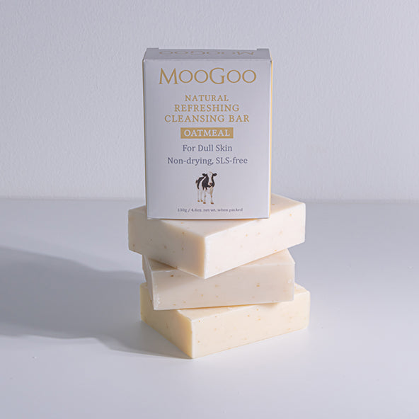 MooGoo Oatmeal Cleansing Bar with box on stacked soap bars, 130g natural cleanser for dull skin, SLS-free