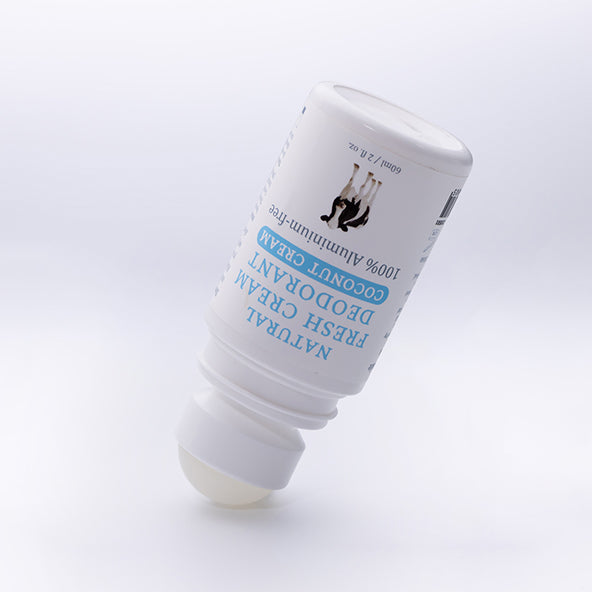 MooGoo Coconut Cream deodorant roll-on displayed open on soft white surface, natural aluminium free formula for sensitive underarms