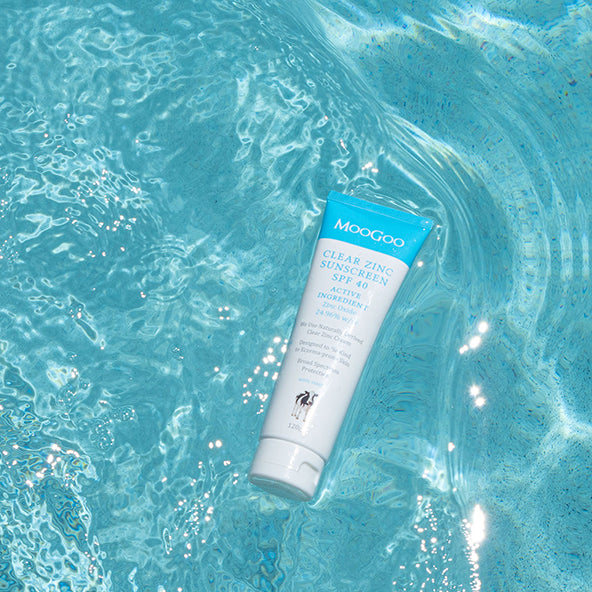 MooGoo Clear Zinc Sunscreen SPF 40 floating in pool, natural zinc oxide sunscreen for sensitive skin with broad spectrum UVA UVB protection
