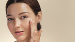 Woman applying facial moisturiser with hyaluronic acid