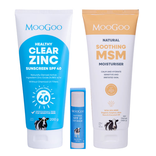Three MooGoo skincare products arranged on a white background: a large blue tube of Healthy Clear Zinc sunscreen SPF 40, a smaller blue tube of Natural SPF 15 Lip Balm, and a large white-and-gold tube of Natural Soothing MSM Moisturiser. MooGoo Summer Essentials Pack for after sun care.