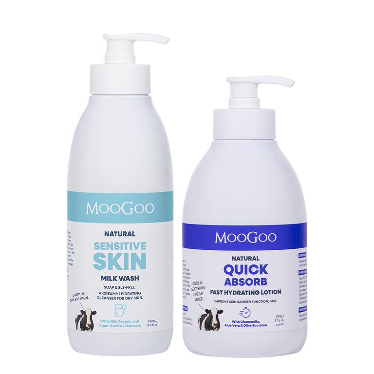 Two white pump bottles of MooGoo skincare products on a white background: Natural Sensitive Skin Milk Wash on the left with a light blue label, and Natural Quick Absorb Fast Hydrating Lotion on the right with a dark blue label. Creamy Hydrating Cleanser and Lightweight Lotion To Replenish Dry, Sensitive Skin. 