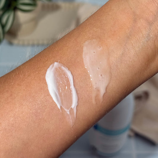 Swatch of MooGoo Milk Wash and MooGoo Fast Hydrating Lotion on a person's arm with a blurred background