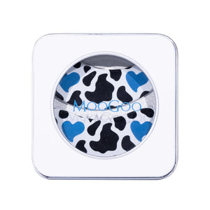 MooGoo square white compact case with a circular clear window showing a black and blue cow print reusable under-eye patches. 100% hypoallergenic silicone to lock in moisture and hydration from skincare and eye serum. 