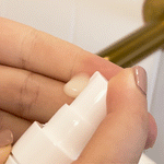 Woman applying MooGoo Hyaluronic Acid and Niacinamide Active Serum to face, lightweight daily serum to reduce fine lines and improve skin tone balance