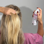 MooGoo Natural Frizz Fighter Hydrating Hair Mist in use, woman spraying product to reduce frizz and boost shine with pro vitamin B5