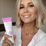 Close-up of MooGoo Protein Shot Leave-In Conditioner tube held by model, natural formula for stronger and healthier hair