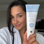 Close-up of MooGoo Full Cream Moisturiser tube in hand, nourishing face and body cream for all skin types and ages