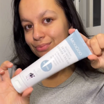 MooGoo Skin Milk Udder Cream held by person inside, cult-favourite natural cream with milk protein to improve elasticity and hydrate skin.