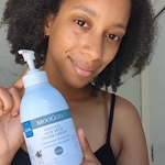 MooGoo Skin Milk Udder Cream held by person inside, cult-favourite natural cream with milk protein to improve elasticity and hydrate skin.