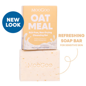 MooGoo Oat Meal SLS-free non-drying cleansing bar shown with its peach-colored packaging box and the actual bar below. Includes a blue 'NEW LOOK' badge and text reading 'Refreshing Soap Bar for Sensitive Skin'. For dull skin, gentle and SLS-free. 