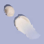 Natural Shea Sorbet Vanilla Butter Balm texture smear on purple background, thick balm for cracked hands and heels