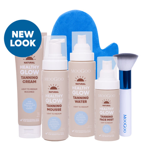 MooGoo Ultimate Tanning Bundle on plain background, includes tanning mousse, water, face mist and cream with blending brush and mitt for radiant skin