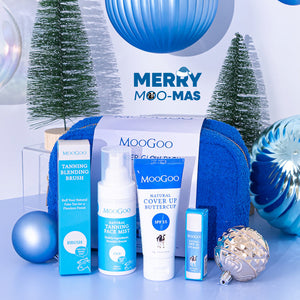 MooGoo Summer Glow Pack with blue bag on Christmas-themed background, includes tanning face mist for bronzed glow, SPF moisturiser and SPF 15 lip balm.