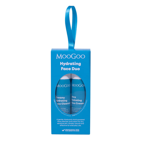 MooGoo Hydrating Face Duo gift set in a bright blue hanging box with one mini creamy hydrating face cleanser and one ultra hydrating face cream, visible through a circular window, on a plain white background.